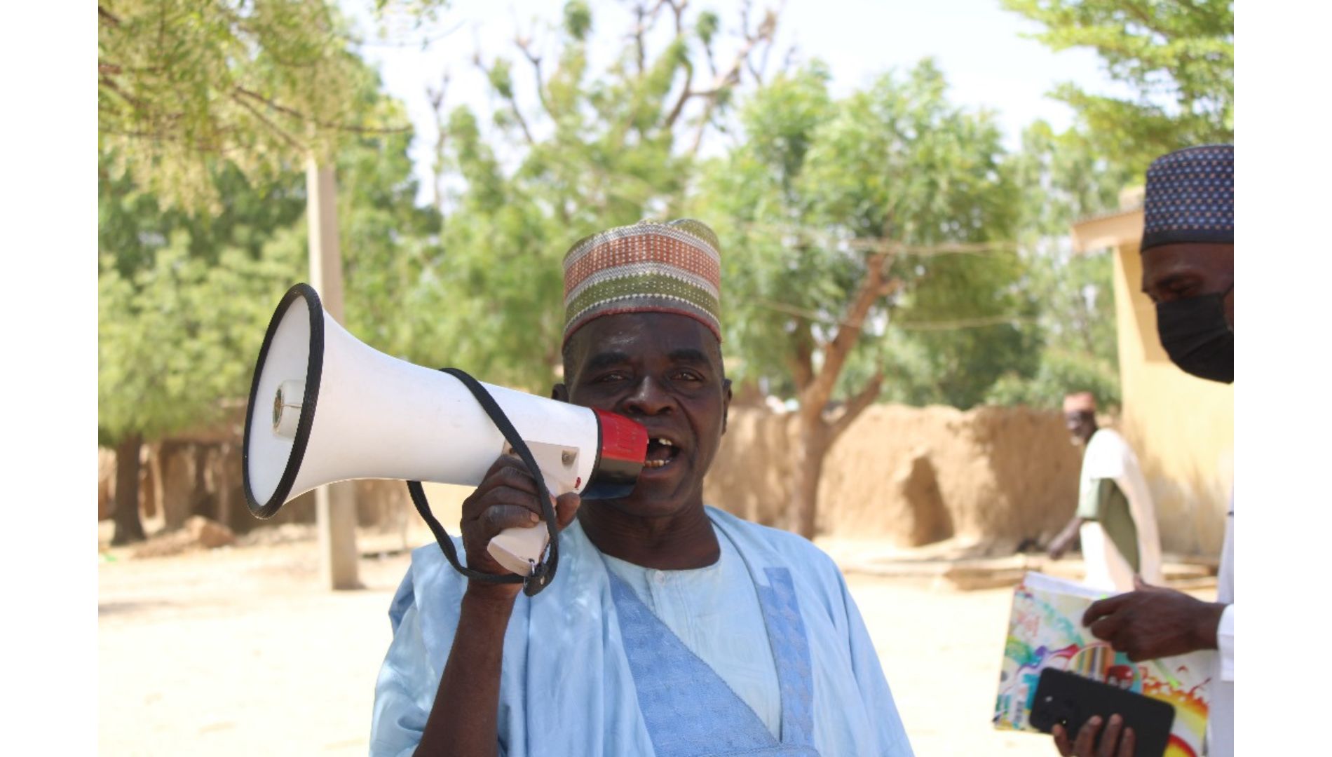 a town crier, Mr Usman calling on parent to get their children to the vaccination post to recieve the MenFive vaccine Photo credit – Ayodamola Owoseye
