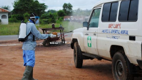 A_health_worker_sprays_disinfectant_on_an_ambulance_in_Nedowein_Liberia_in_July_2015.JPG
