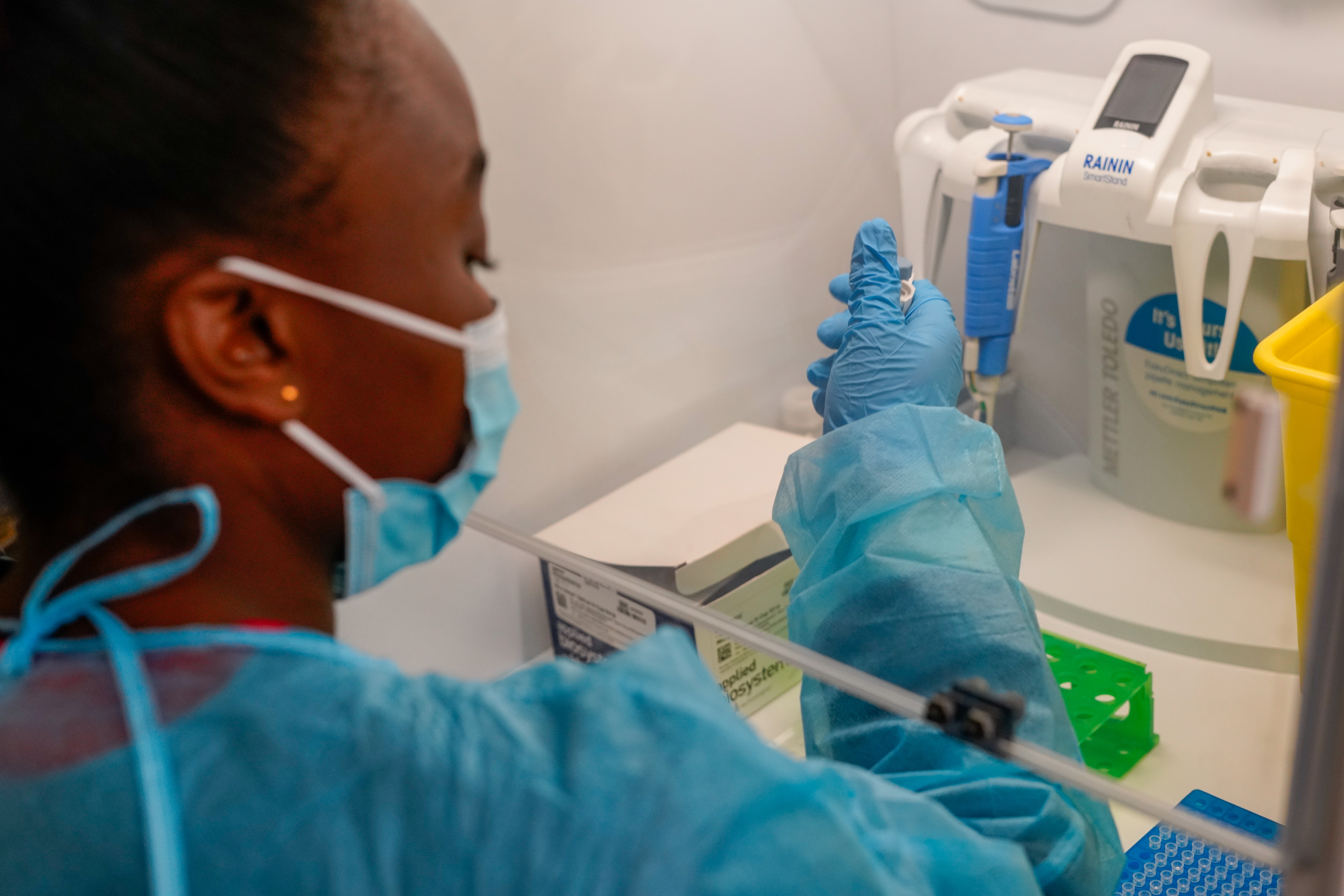 A staff at the national reference laboratory prepares specimen for genomic sequencing