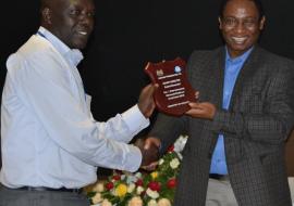 Elgeyo Marakwet director Mr William Kendago receives best award for county immunization performance  from Dr Jackson  Kioko, DMS