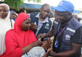 WHE Emergency Manager, Dr. Collins Owili vaccinates a child against cholera during the flagoff ceremong of the OCV campaign in Borno state. Credits: WHO CE.Onuekwe