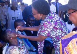 Minister of Health Dr Jane Ruth Aceng vaccinates a member of the community at the launch 