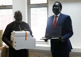 Dr Olu handing over the ICT equipment to Dr  Makur, Undersecretary, Ministry of Health