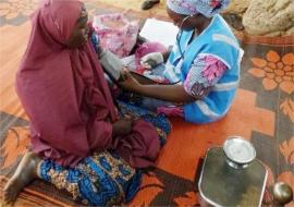 A member of the hard-to-reach team providing support to a patient in Borno State.