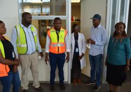 The Minister (2nd from right) and WR (far right) discussing with Port Health Officers and Airport Staff