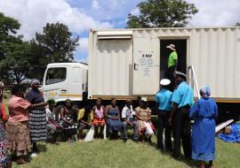 People queuing for TB screening in one of the mobile x ray vans 