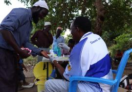 A project assistant collecting blood sample for testing 
