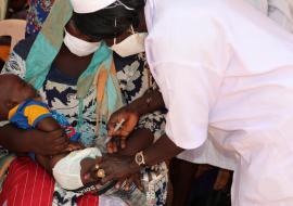 A health worker gives an injectable inactivated polio vaccine in Juba
