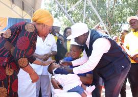 WR a.i. Dr. Zabulon Yoti giving polio drops to a child at the launch event