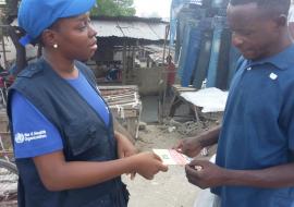 WHO staff interacting with a community member during the supportive supervision mission