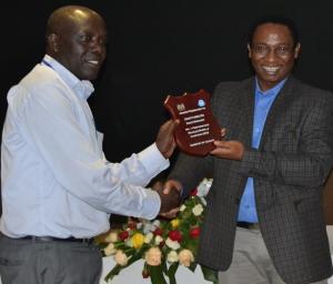 Elgeyo Marakwet director Mr William Kendago receives best award for county immunization performance  from Dr Jackson  Kioko, DMS
