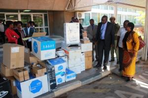 Dr. Mary Katepa Bwalya, OIC at WHO handing over the medical supplies to the Minister of Health, Dr. Chitalu Chilufya (left) in the presence of Dr. Victor Mukonka, Director at the National Public Health Institute