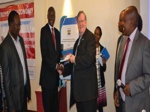 WR Kenya Dr Rudi Eggers receives a copy of the National guidelines for Tobacco Dependence Treatment & Cessation from Dr Patrick Amoth, MOH, while others look on