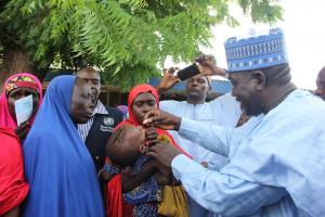 Head of Service,  vaccinating a child with oral cholera vaccine at Muna IDPs camp in Borno state.
