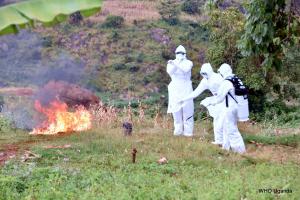 The burial team burning the bedding and and clothes of the dead MVD confirmed case in Kween district