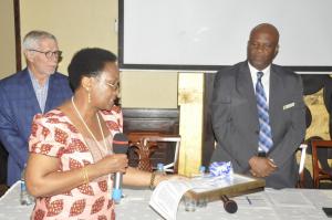 On behalf of the WR, Dr. Ritha Njau handing over the Award to the Chief Medical Officer, Prof. Mohammed Bakari Kambi