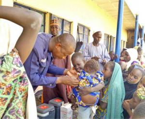 Dr Bamusa Bashir of WHO vaccinates an eligible child in Gajigana, Magumeri LGA during the ongoing measles reactive vaccination campaign in Borno state. Photo WHO