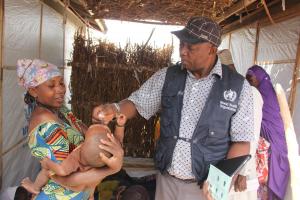 WHO Pharm Oche administers cholera vaccine to an eligible beneficiary the OCV campaign 