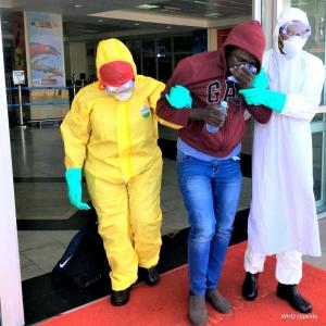 Health workers evacuate a suspected Ebola patient at Entebbe International Airport during the SIMEX 