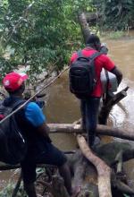 The team crossing a river on their way to Japuken