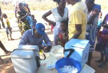 WHO vaccination staff member completes vaccination cards in Huambo WHO/M Marrengula