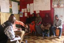 A WHO/UNICEF Risk Communication team member explains AWD prevention and control to health workers and residents of Gabo Gabo Kabele using pictorial posters (Photo: Ms Tseday Zerayaco)