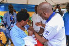 Rotary Club President administering polio vaccine