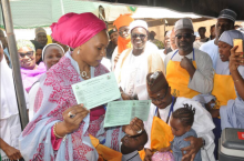 Wife of the Governor of Kaduna State Hajiya Ummi El Rufai proudly displaying her children’s vaccination cards