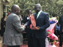 Mr Liyosi, the WHO Representative a.i.  receiving awards from the Governor of Budi state in Yambio.