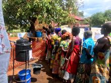 Cholera patients and their care-takers receive meals at Kasango Cholera treatment center 