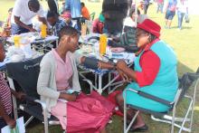 A health worker measuring Blood Pressure of a community member