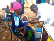 l'infirmier chef de poste de Leguema vaccine un enfant