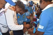 Governor Charity Ngilu vaccinates a child at the national launch of Round 2 Campaign held in Kitui County