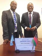 Dr Charles Mwansambo on the right displays the award after it was accepted by the Malawi Minister of Health at UN building conference