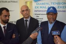 Dr L. Musango, WHO Representative in Mauritius, talking to the media in the presence of  Dr Hon K. Jagutpal, Minister of Health and Wellness  (centre) and Dr Hon M.I. Rawoo, Parliamentary Private Secretary