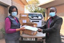 Louis Mukumba receiving office equipment on behalf of City of Harare 