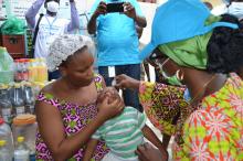 Madame Djanabou MAHONDE, Représentante Résidente de l’Unicef vaccine un enfant dans l’aire sanitaire de Zogbo