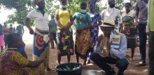 Nations Unies Bénin, A.Y - Le Coordonnateur Résident des Nations Unies discutent avec le groupement des femmes du village de Tédontè, près de Kouaba, qui ont appris à fabriquer du savon grâce aux interventions de l’UNICEF et qu’elles fournissent à l’école du village. 