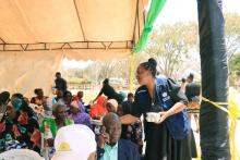 WHO staff, Ms. Zawadi Sweke providing refreshments to the invited older persons