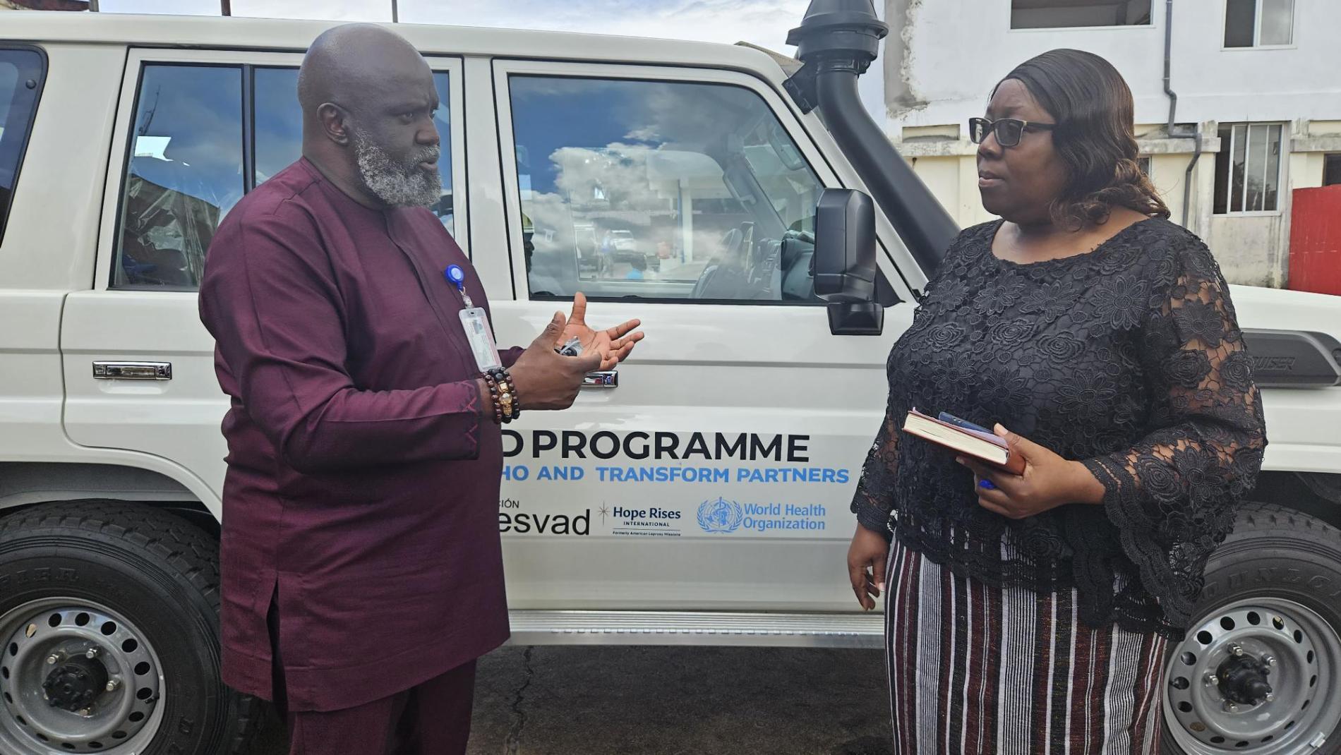 WHO Representative Dr Olu Olushayo handing over the vehicle to Dr Catherine Cooper, Chief Medical Officer at Ministry of Health