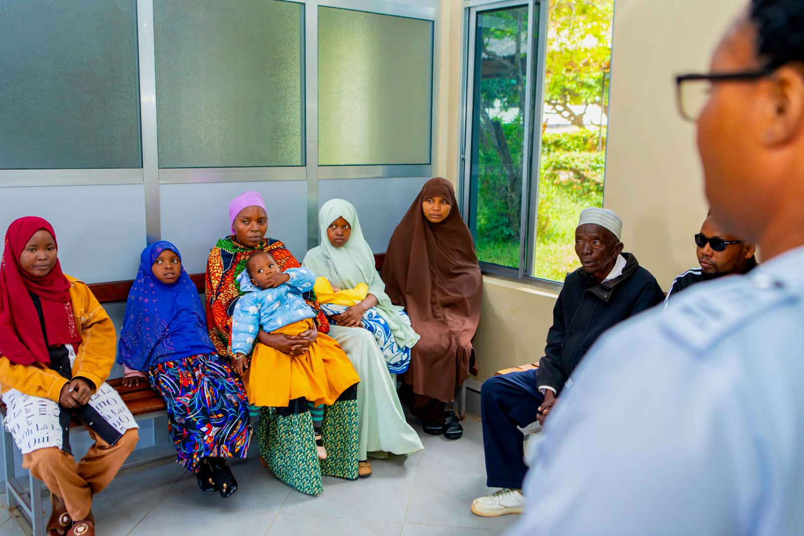 A nurse providing a health education session to patients during a routine clinic day at the PEN-Plus facility in Kondoa. These group sessions are vital for teaching self-management skills to individuals living with chronic conditions like diabetes, sickle cell disease, and heart disease.