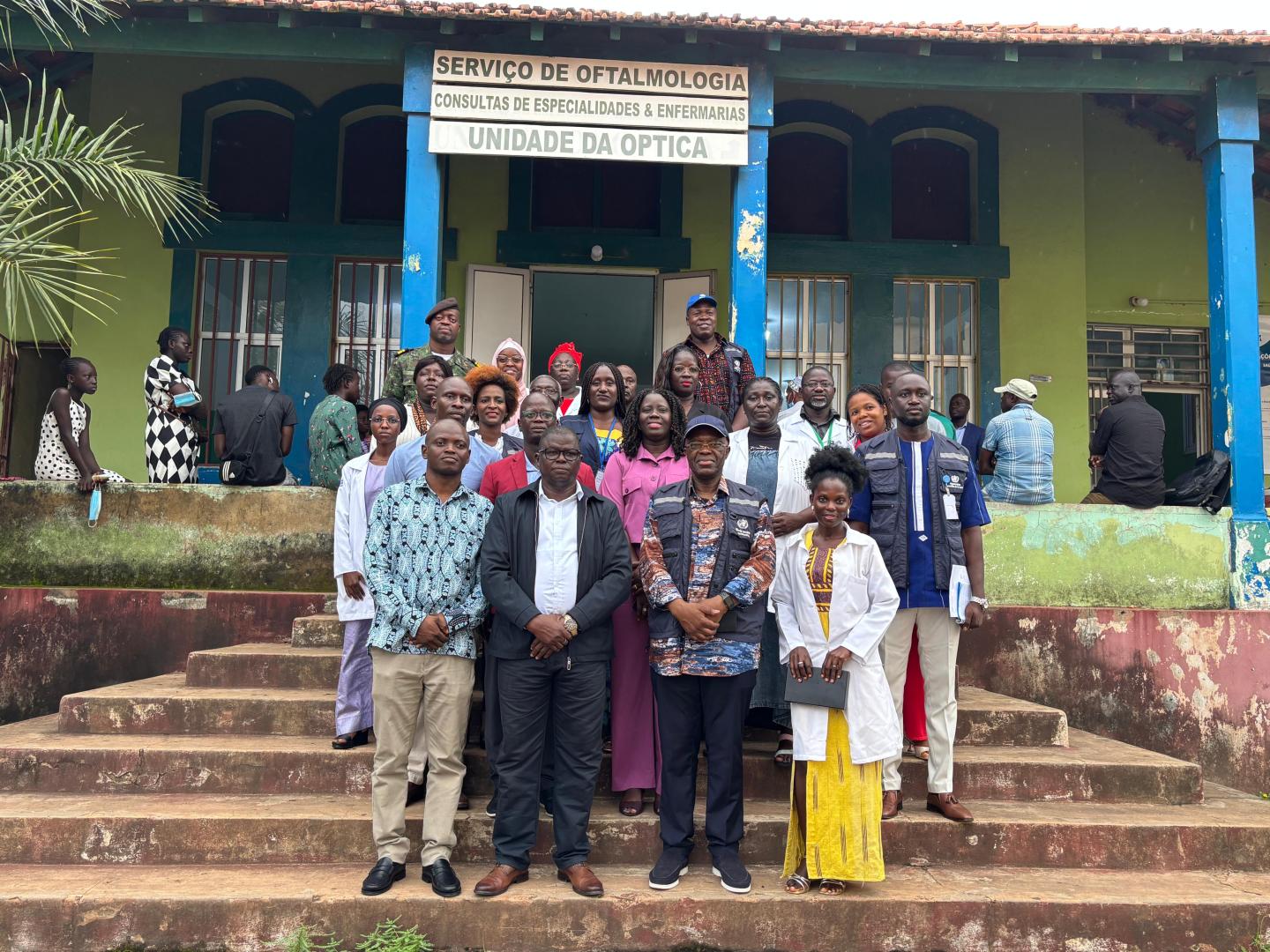 pose for a group photograph outside the Ophthalmology Service at Simão Mendes National Hospital in Bissau.