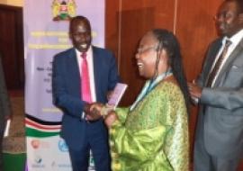 Health PS, Prof Segor hands a copy of the guidelines to the WR, Dr Custodia during the launch