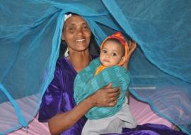 A grandmother with her granddaughter in a bednet, Shebedino Woreda, Hawassa.