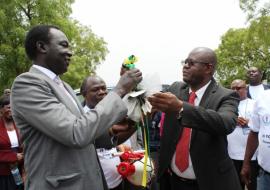 Dr. Manzila, WHO Representative to South Sudan hands the bunch of keys for the ambulances to Dr. Makur Matur Kariom, Undersecretary in the Ministry of Health