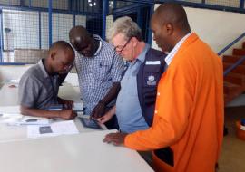 WHO and MoH staff checking on the Ebola Cold Chain freezers that were delivered WHO and MoH staff checking on the Ebola Cold Chain Freezers that were delivered
