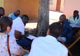 Participants interviewing a community member who once suffered from malaria