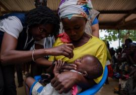 Dr Sally Ann Ohene, Disease Prevention and Control Officer in WCO dosing a child in Ando Nymadou, a community in Chereponi District