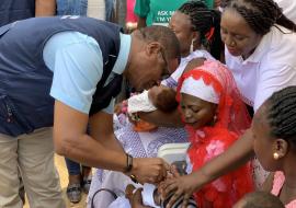 Country Representative of WHO, Dr Owen Kaluwa vaccinating a baby