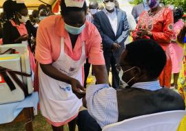 Health worker vaccinates a resident of Moyo District against Yellow Fever